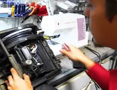 Vacuum repair technician servicing internal components on a workbench in Little Rock, AR