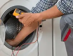 Washing machine repair technician testing a front-load washer with diagnostic tools in Little Rock, AR