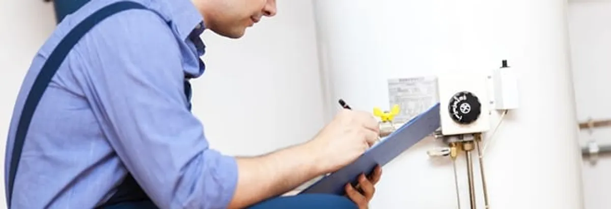 Water heater repair technician inspecting the unit and recording service notes in Little Rock, AR